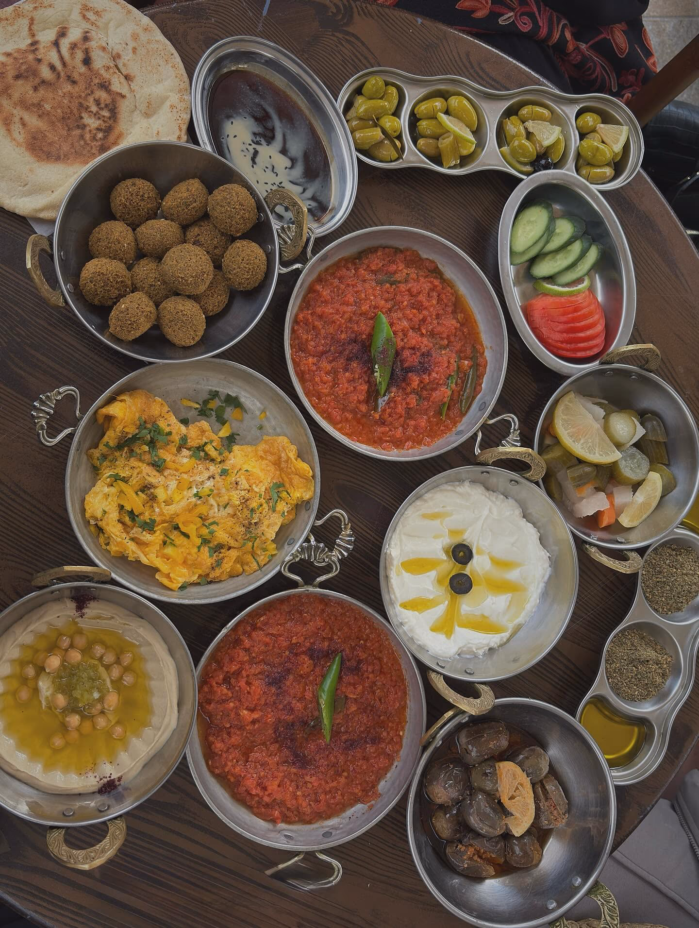 Traditional Jordanian food spread with hummus, falafel, bread and colorful dishes